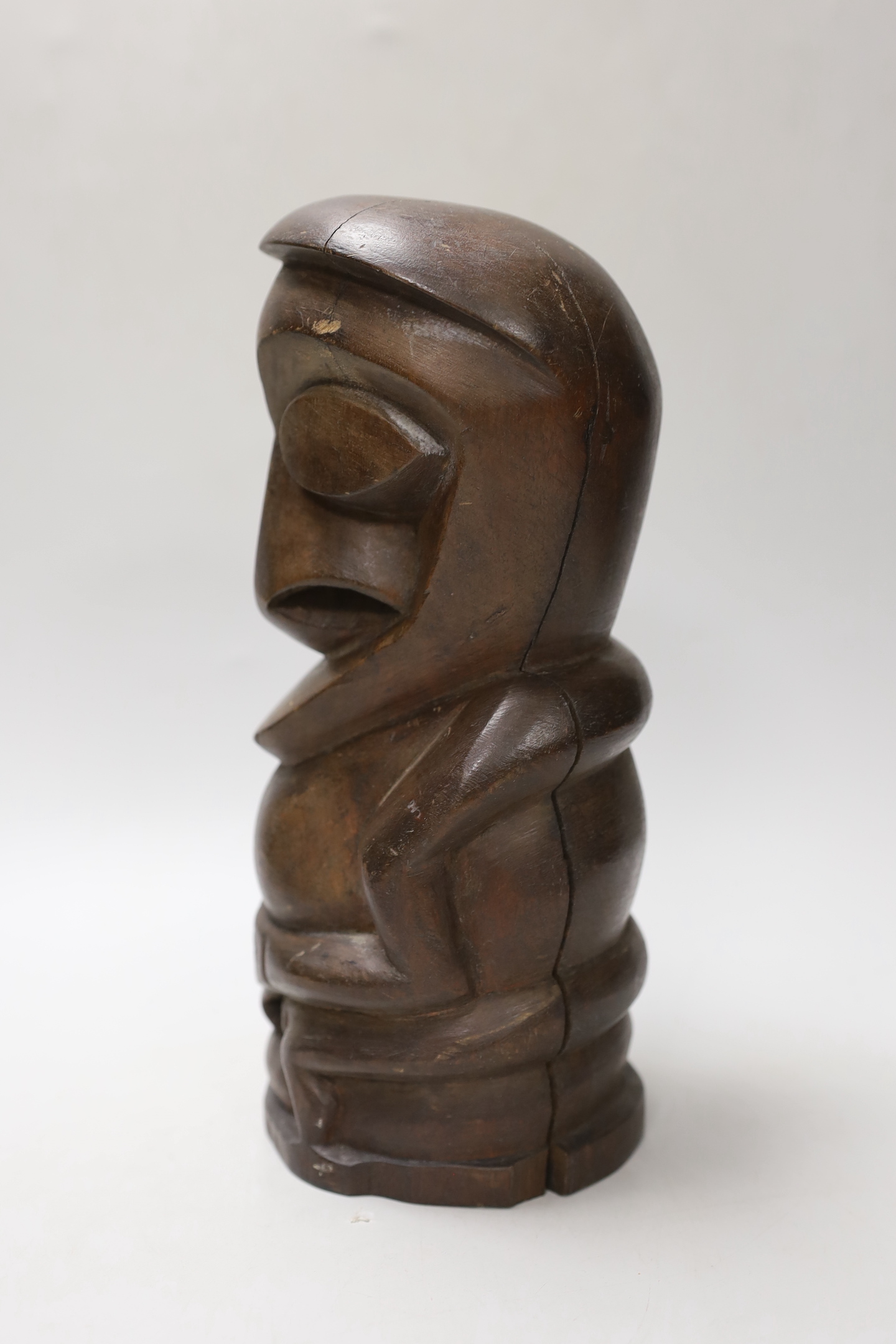 A Maori-type carved hardwood totem figure, 26cm high